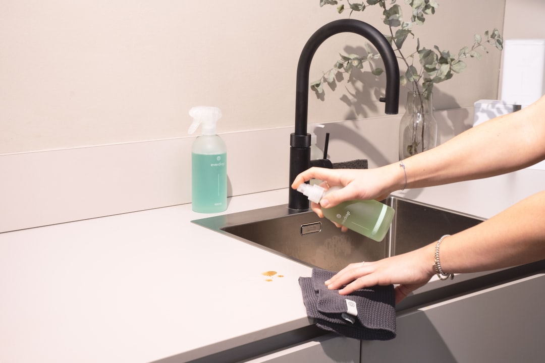about-02 a-woman-is-cleaning-a-kitchen-sink-with-a-rag-sqomdoqb3ws